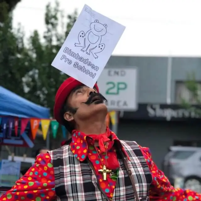 person balances a Bimbadeen colouring paper on their nose